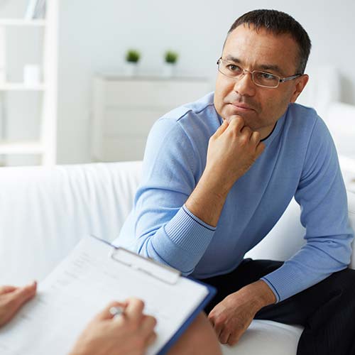man on couch of mental health outpatient program treatment