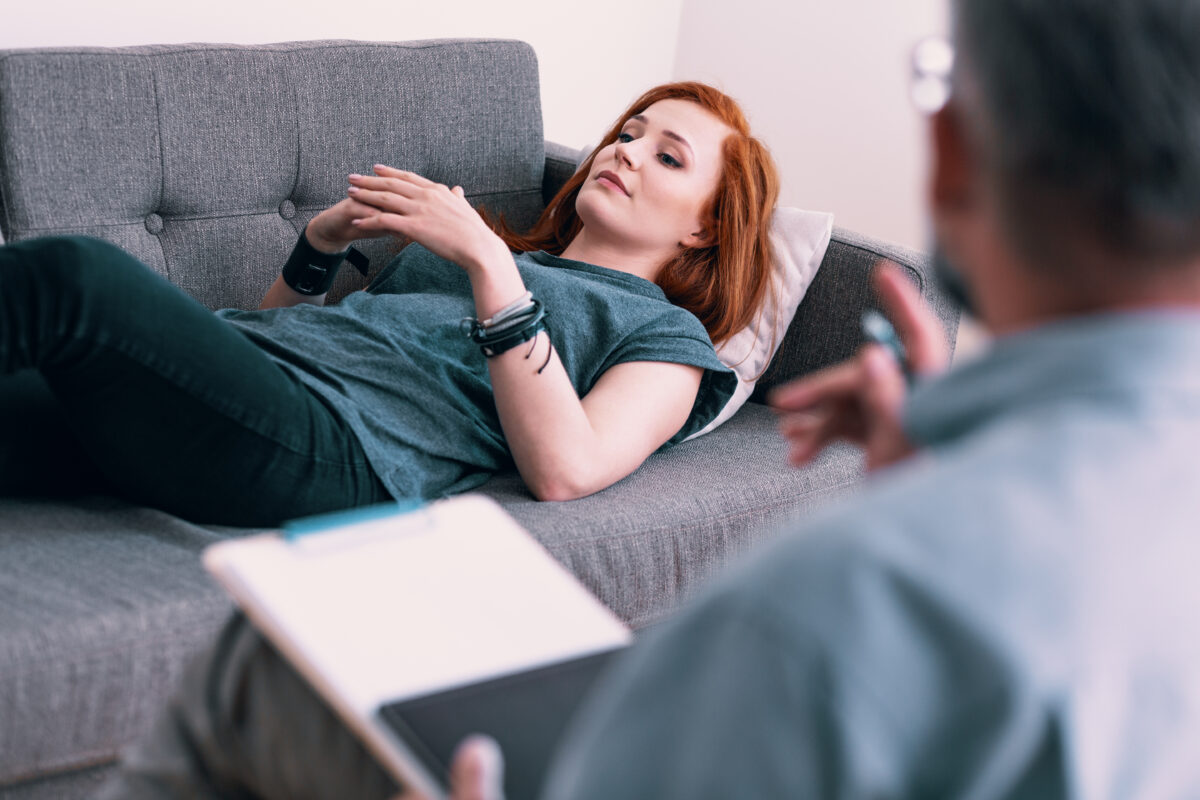 burnout therapy session woman on a couch discussing burnout symptoms